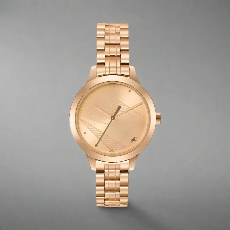 Fastrack 6267WM01 women's analog watch featuring a stylish white dial, gold-tone stainless steel case, and a chic gold metal strap. A sophisticated and fashionable timepiece for every occasion.