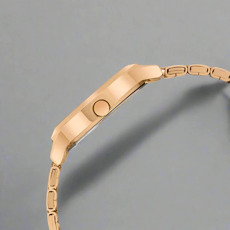 Fastrack 6267WM01 women's analog watch featuring a stylish white dial, gold-tone stainless steel case, and a chic gold metal strap. A sophisticated and fashionable timepiece for every occasion.