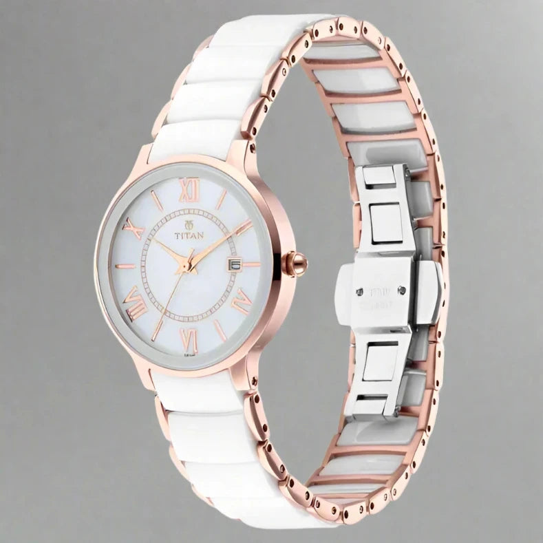A sophisticated Titan women's watch featuring a gold-tone stainless steel strap, an elegant white dial, and a classic analog design, perfect for timeless style and everyday wear.