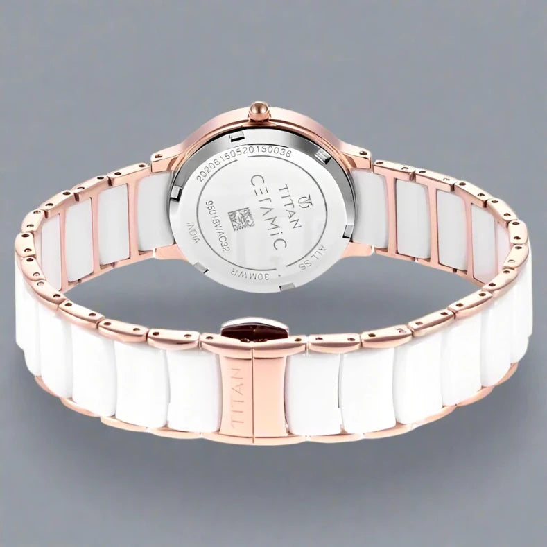 A sophisticated Titan women's watch featuring a gold-tone stainless steel strap, an elegant white dial, and a classic analog design, perfect for timeless style and everyday wear.