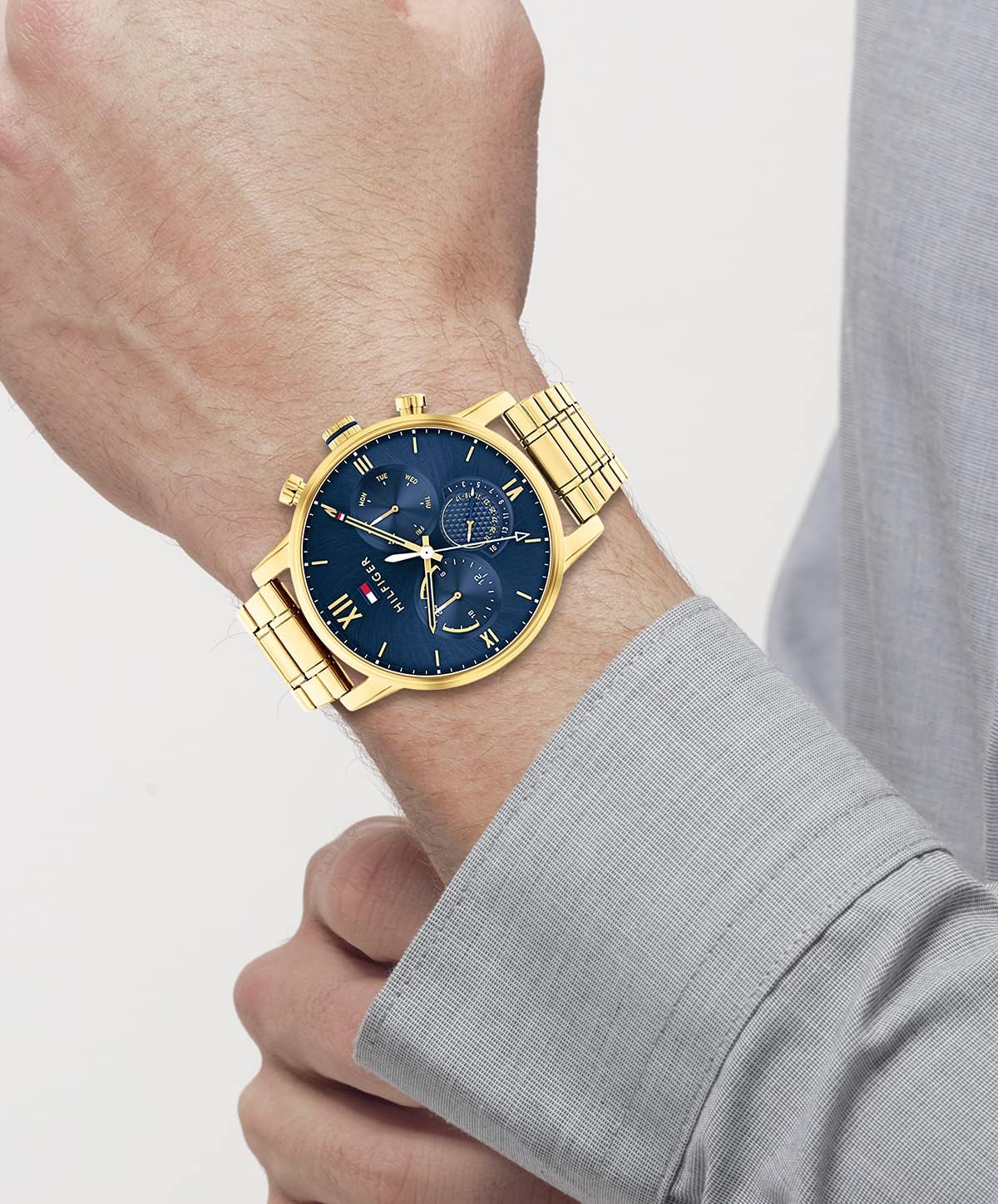 Wearing View Of Tommy Hilfiger 1791880 Men's Watch with Blue Dial, Gold-Tone Stainless Steel Case, and Chronograph Functionality