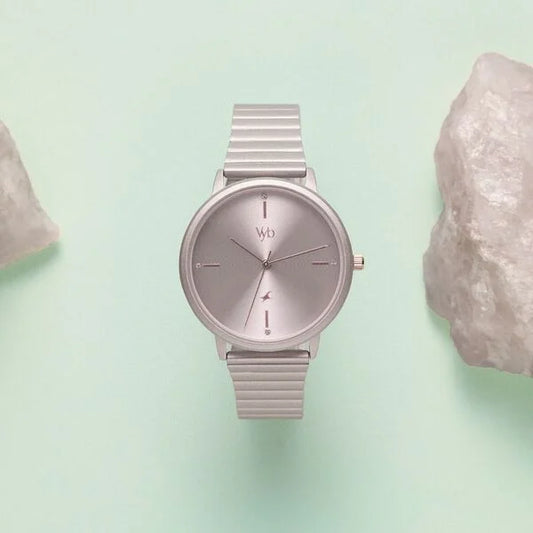 Silver watch with a mesh band on a light green background Modern women’s watch FV60021KM07W by Fastrack