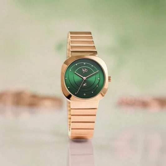 Gold watch with a green face Fastrack VYB FV60077WM02 quartz wristwatch
on a blurred background