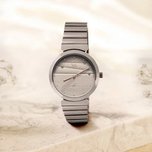 Silver watch with a detailed face on a marble surface