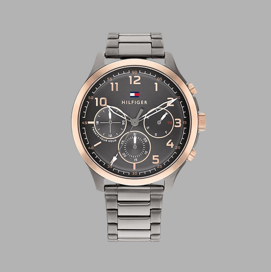 Tommy Hilfiger 1791871 Men's Watch with a grey dial, gold-accented sub-dials, stainless steel case, and silver strap. Features chronograph functionality and a sleek design.